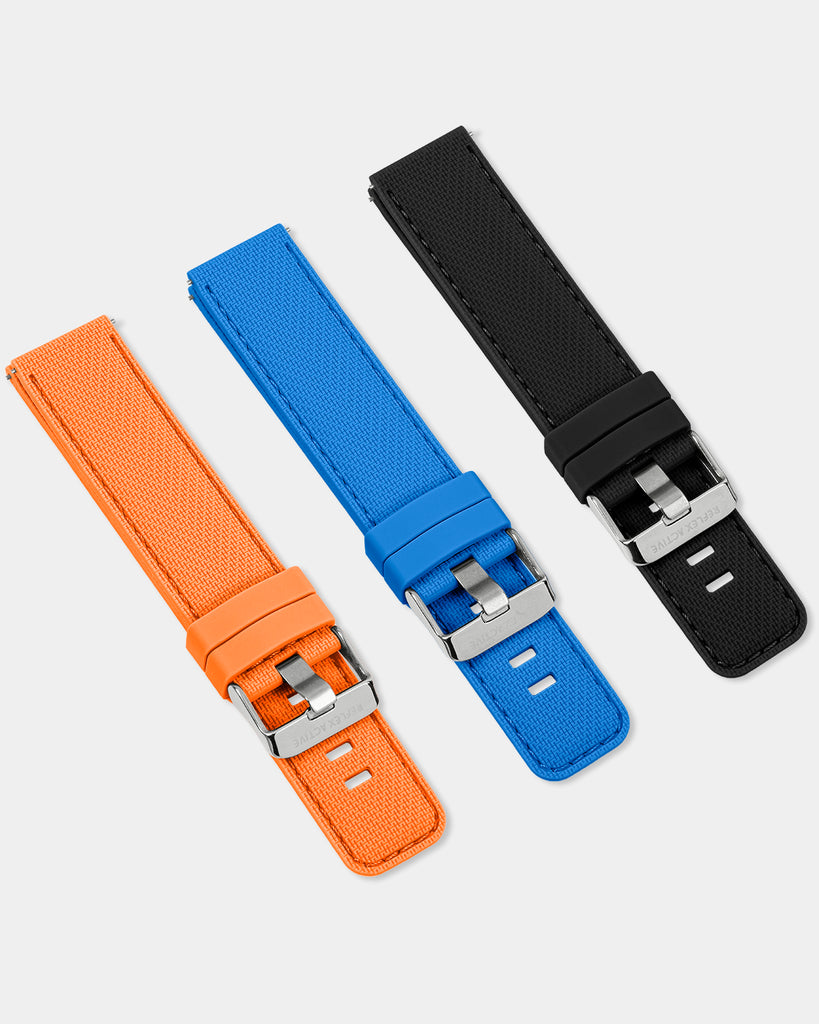 Three different colors of Reflex-Active 20mm Interchangeable Strap Pack - Blue, Black, & Orange silicone watch straps featuring a quick-release mechanism, arranged on a white surface.