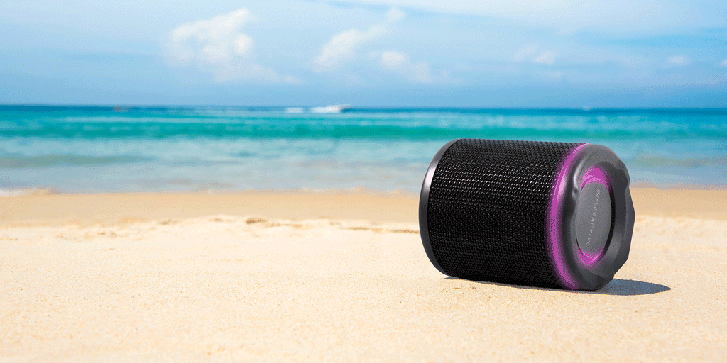 wireless portable speaker with flashing lights on sunny beach